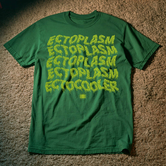A kelly green short-sleeve t-shirt laid flat on a brown carpeted floor, featuring the word 'ECTOPLASM' repeated in a yellow-green dripping font, with 'ECTOCOOLER' printed below in a smaller solid yellow-green font.