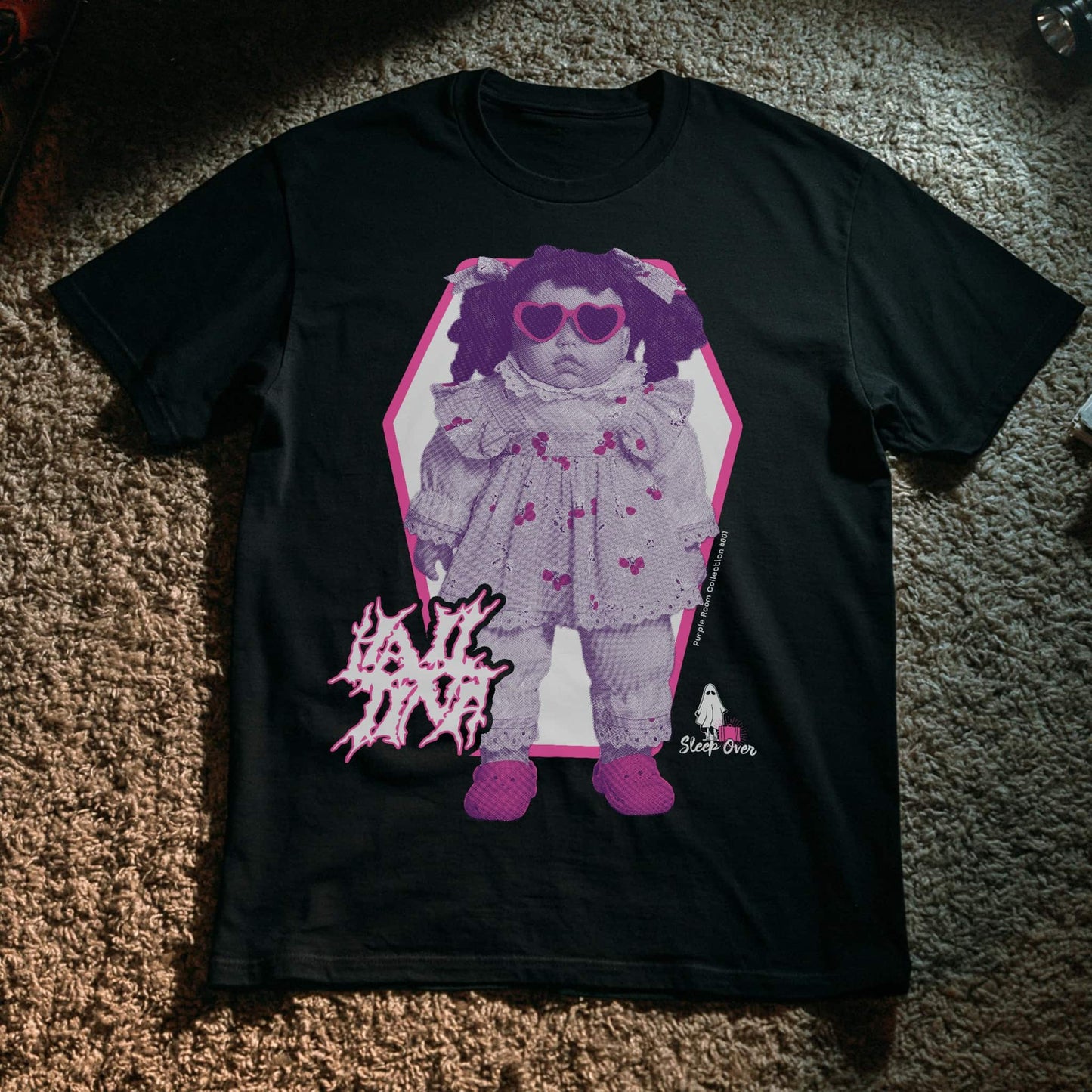 Hail Tina, a haunted doll graphic t-shirt from the SleepOver Purple Room Collection.