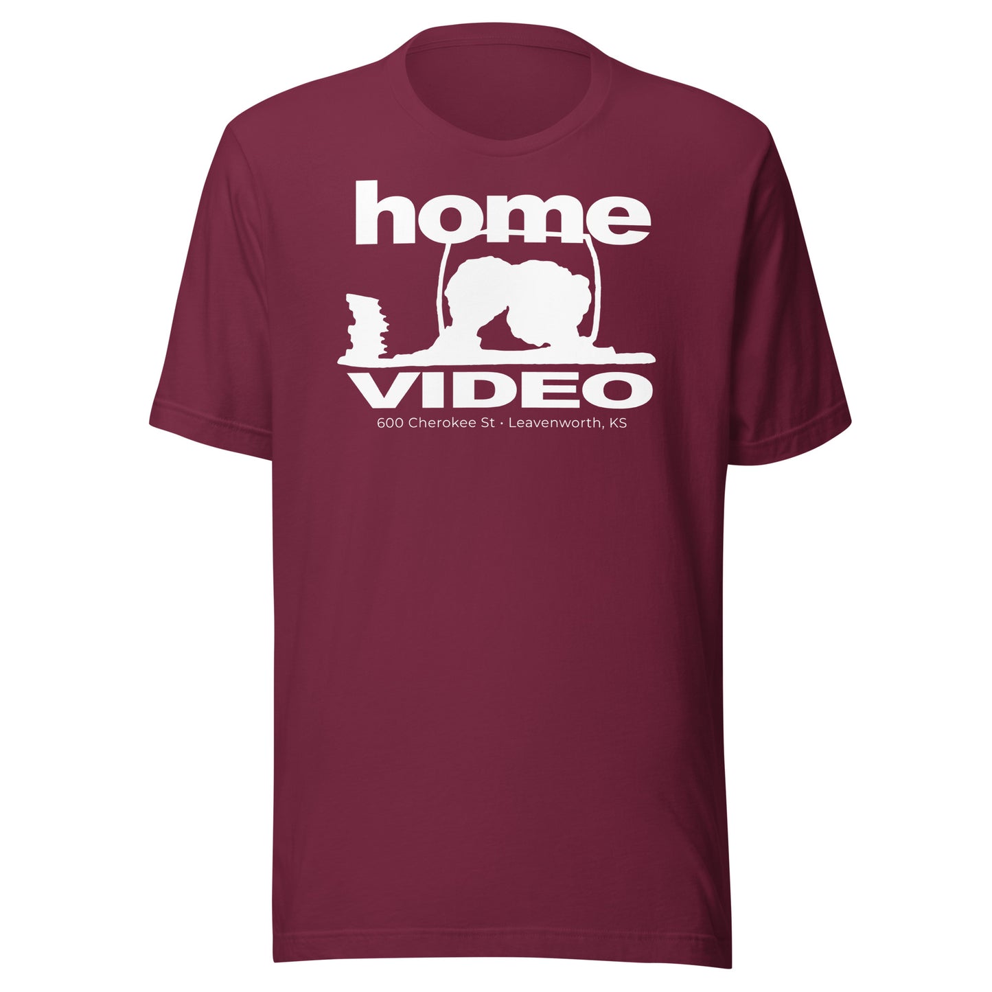 Maroon T-shirt with a retro-style white logo reading “Home Video” and an outline of a person crouched near a TV screen, with text “600 Cherokee St • Leavenworth, KS.”