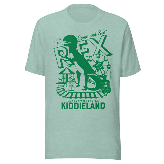 T-shirt featuring a retro green graphic of a dinosaur named Rex, a Ferris wheel, train tracks, and the text “Come and See Rex – Kiddieland – Leavenworth, KS – 1948–1998.”