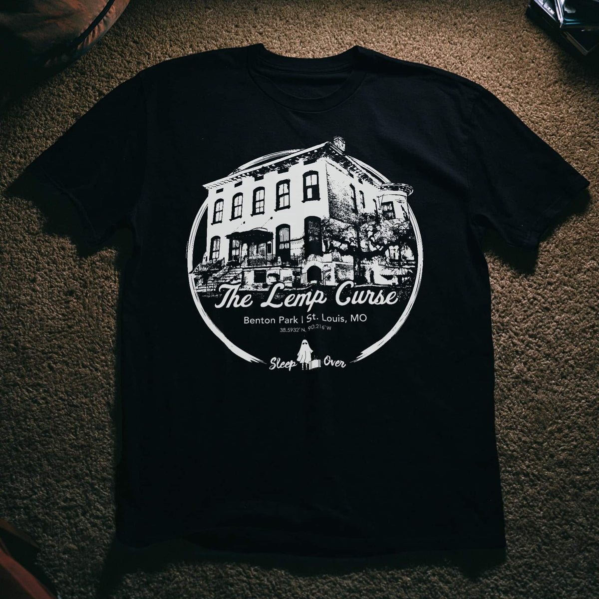 Black tee with Lemp Mansion illustration and 'The Lemp Curse' badge design, SleepOver Clothing.