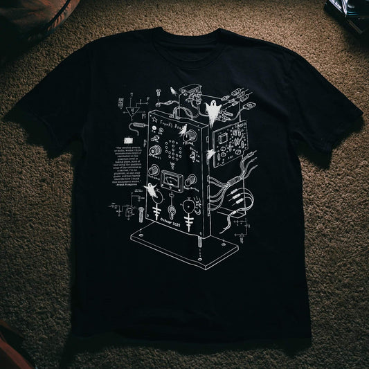 Exploded diagram of Frank’s Box spirit communication device with ghostly details, white technical line art on black T-shirt by SleepOver Clothing.
