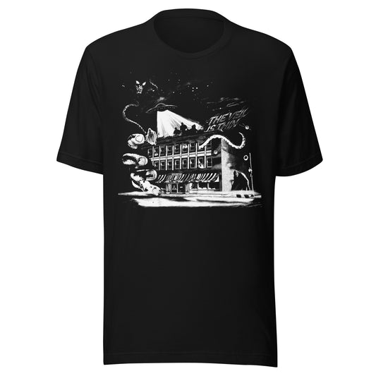 The Veil Is Thin graphic t-shirt featuring a ghost, UFO, Bigfoot, and tentacle emerging around a haunted storefront building at night